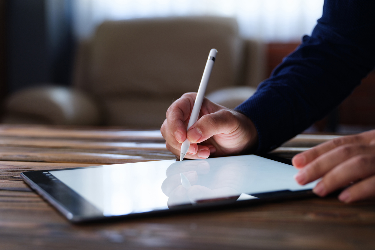 Businessman Signing Digital Contract On Tablet Using Stylus Pen
